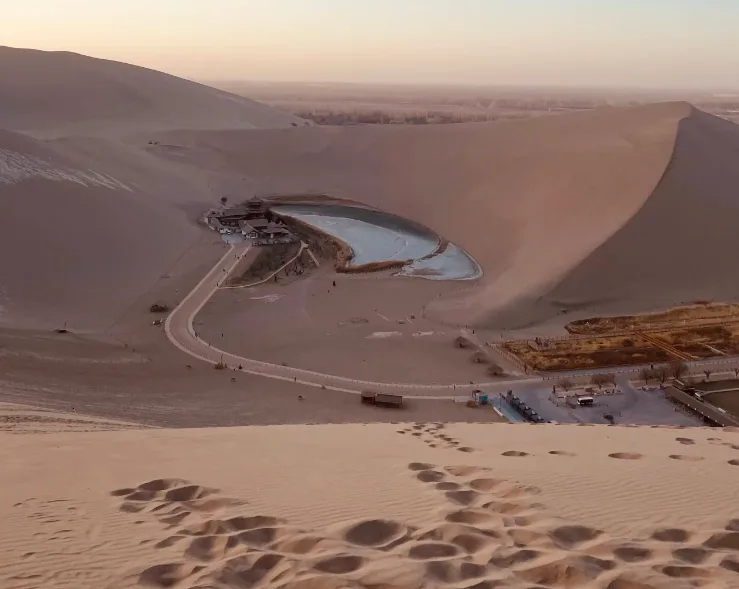 Crescent Moon Lake amid golden dunes